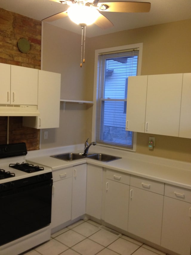 kitchen featuring ceiling fan, sink, white gas range, custom exhaust hood, and white cabinetry