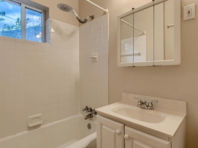 bathroom featuring vanity and tiled shower / bath