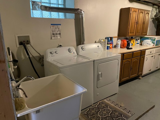 laundry room featuring cabinets, separate washer and dryer, and sink