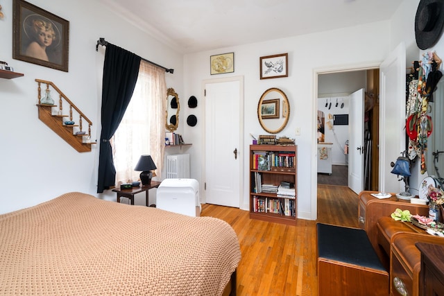 bedroom with light hardwood / wood-style floors and radiator