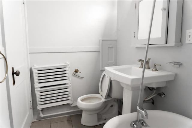 3012 Aldrich Ave S, Minneapolis, MN 55408 - bathroom featuring tile flooring, toilet, and radiator
