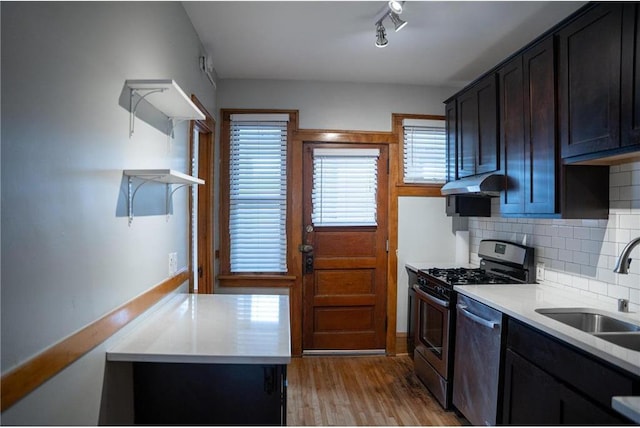 3012 Aldrich Ave S, Minneapolis, MN 55408 - kitchen featuring stainless steel dishwasher, light wood-type flooring, gas range, tasteful backsplash, and sink