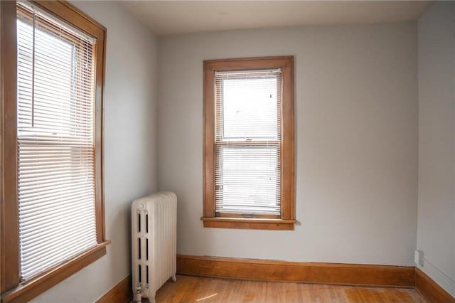 3012 Aldrich Ave S, Minneapolis, MN 55408 - spare room featuring radiator heating unit and light hardwood / wood-style flooring
