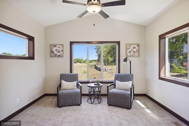 living area with ceiling fan, plenty of natural light, and vaulted ceiling