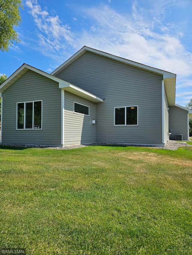 rear view of house featuring a yard