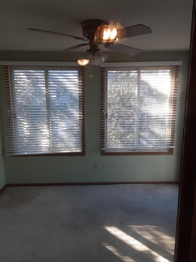 empty room with carpet floors and ceiling fan