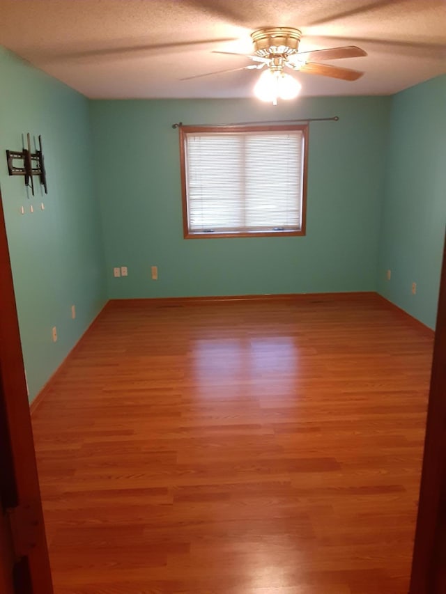 unfurnished room featuring ceiling fan and light wood-type flooring