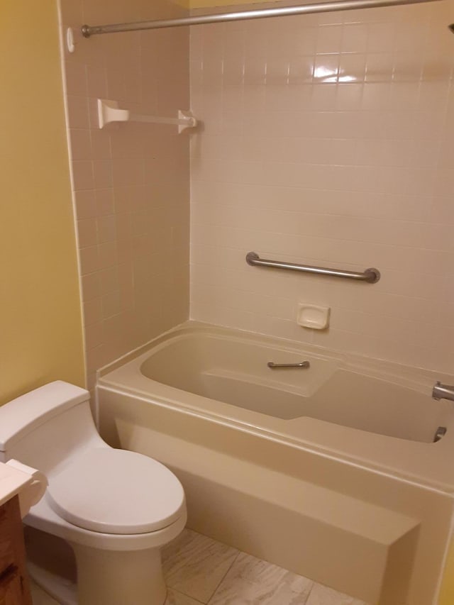 full bathroom featuring tile floors, toilet, vanity, and tiled shower / bath