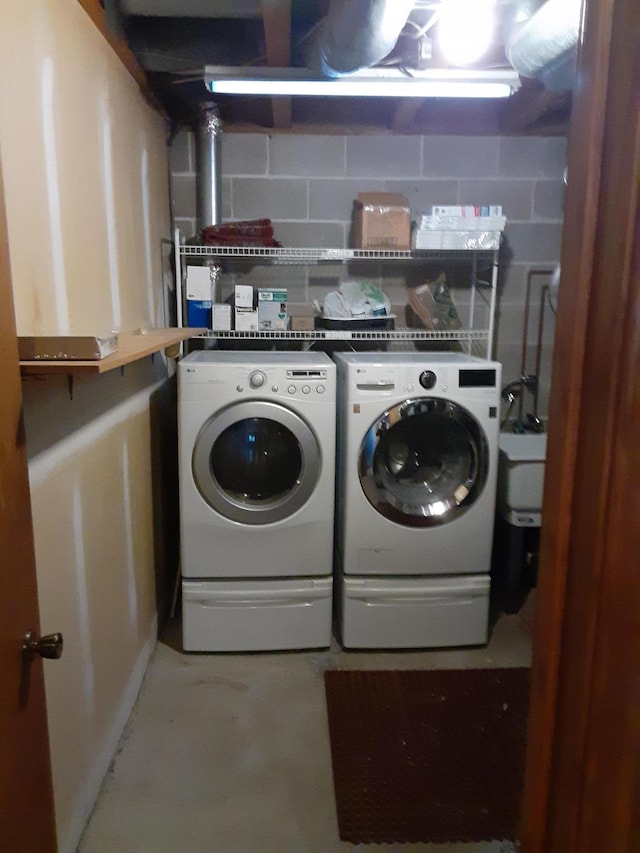 clothes washing area with washer and clothes dryer