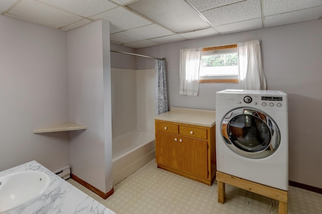 laundry area with a baseboard radiator, sink, and washer / dryer