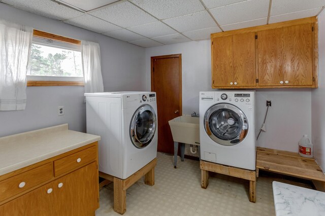 washroom featuring cabinets, washer / dryer, and sink