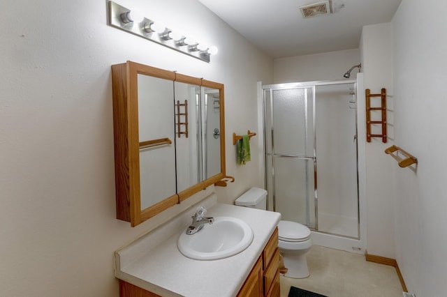 bathroom with toilet, vanity, and an enclosed shower