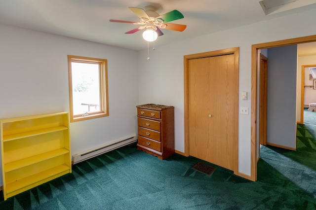 unfurnished bedroom with a baseboard heating unit, dark colored carpet, ceiling fan, and a closet