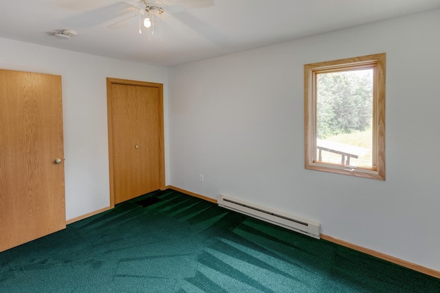 interior space featuring ceiling fan, dark carpet, and baseboard heating