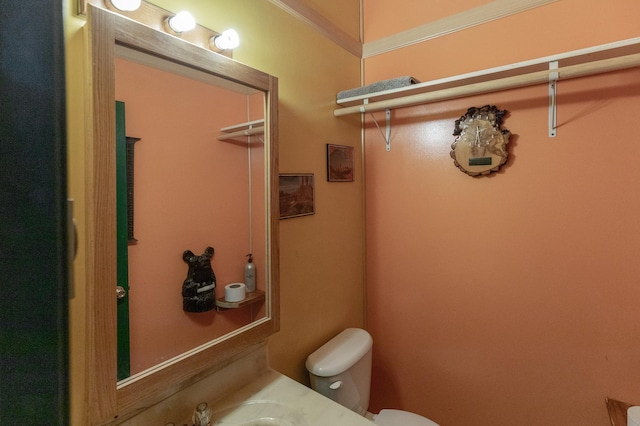 bathroom with toilet and ornamental molding