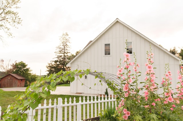 view of property exterior featuring a yard and an outdoor structure