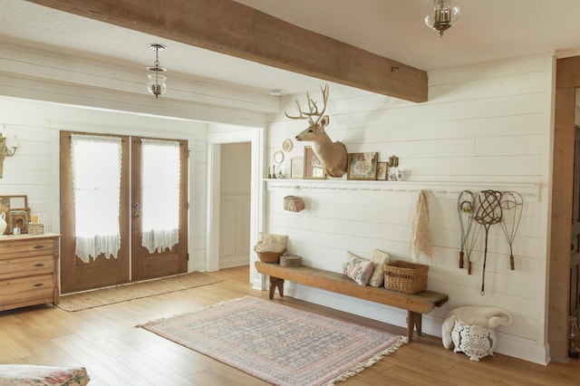 mudroom with beamed ceiling, hardwood / wood-style floors, a textured ceiling, and french doors