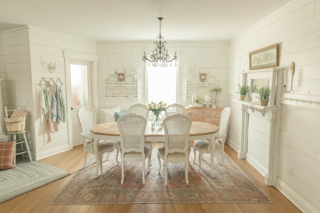 dining area featuring a wealth of natural light, a notable chandelier, and light hardwood / wood-style floors