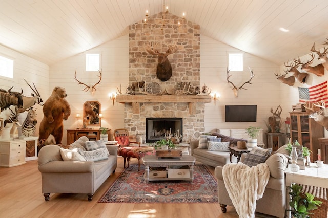 living room with a stone fireplace, high vaulted ceiling, wooden ceiling, and light wood-type flooring