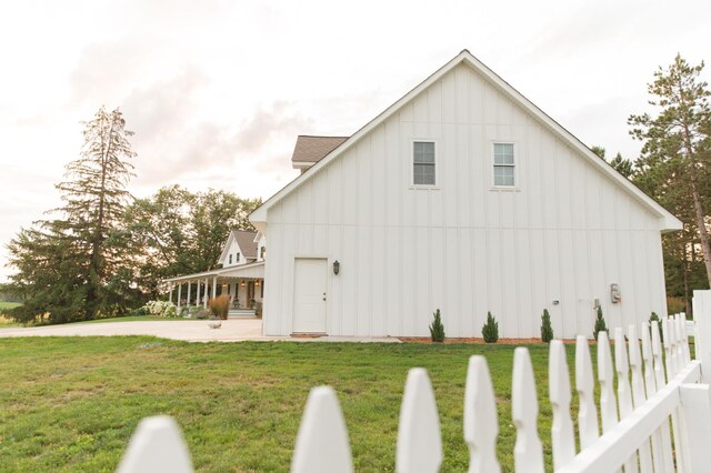 view of home's exterior featuring a lawn and covered porch