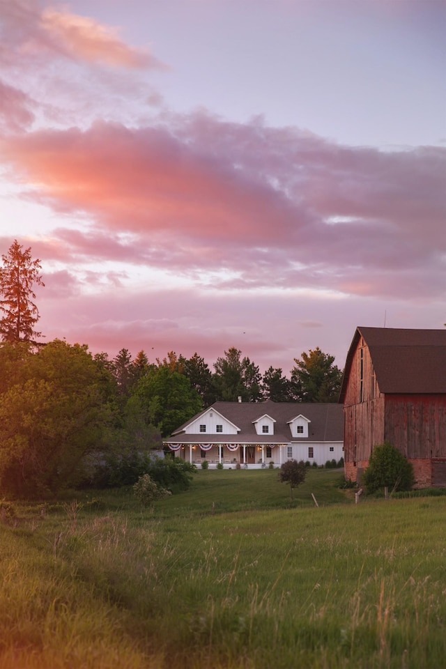 back house at dusk with an outbuilding