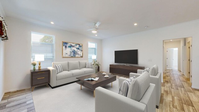 living room with ceiling fan, light wood-type flooring, and a healthy amount of sunlight