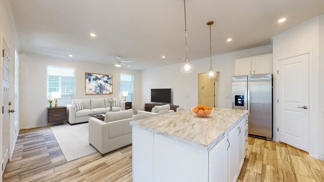 kitchen featuring ceiling fan, white cabinets, a center island, stainless steel refrigerator with ice dispenser, and light wood-type flooring