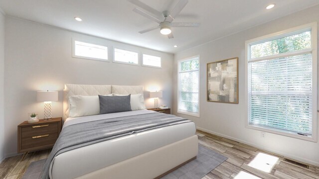 bedroom with light hardwood / wood-style flooring and ceiling fan