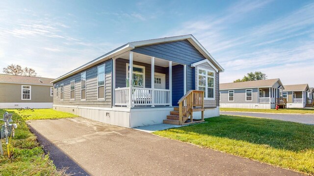 view of front facade featuring a front yard and covered porch