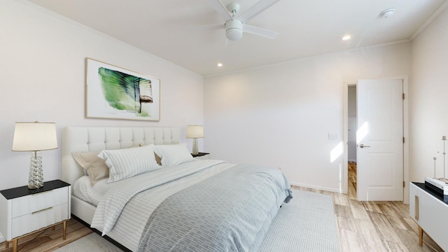 bedroom with ceiling fan, light hardwood / wood-style floors, and crown molding