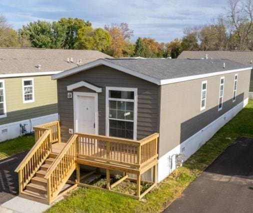 rear view of property featuring a deck