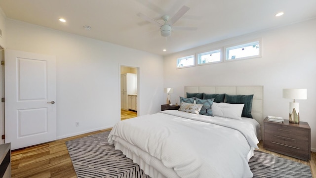 3611 85th St NW Unit 242, Oronoco Twp, MN 55960 - bedroom featuring light wood finished floors, connected bathroom, a ceiling fan, baseboards, and recessed lighting