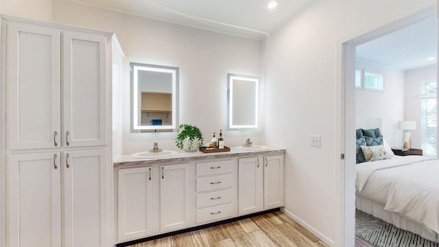 3611 85th St NW Unit 242, Oronoco Twp, MN 55960 - ensuite bathroom featuring double vanity, ensuite bathroom, wood finished floors, and a sink