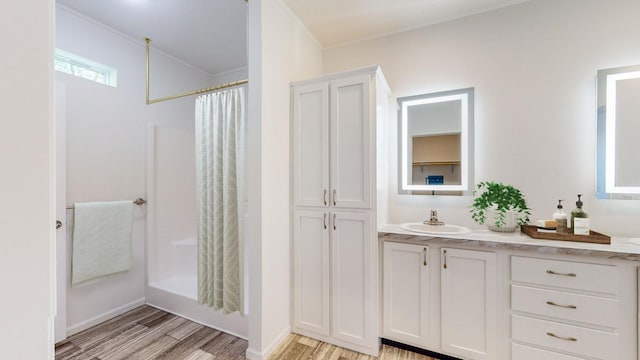 3611 85th St NW Unit 242, Oronoco Twp, MN 55960 - full bath with curtained shower, wood finished floors, vanity, and ornamental molding