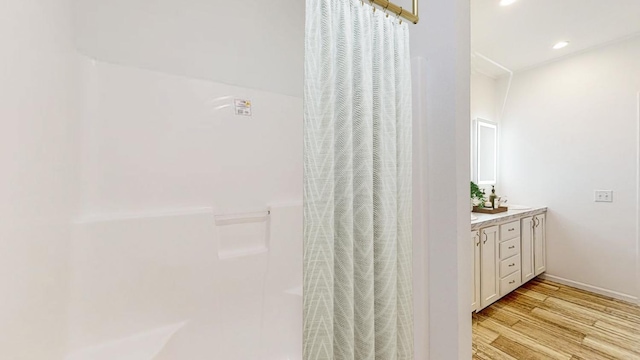 3611 85th St NW Unit 242, Oronoco Twp, MN 55960 - full bath featuring vanity, recessed lighting, a shower with shower curtain, and wood finished floors