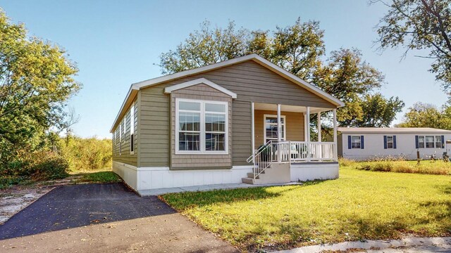3611 85th St NW Unit 242, Oronoco Twp, MN 55960 - manufactured / mobile home with covered porch and a front lawn