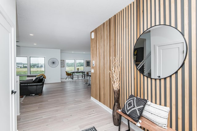 2811 Wildflower Ln SW, Rochester, MN 55902 - hall with recessed lighting, wallpapered walls, an accent wall, light wood-type flooring, and baseboards