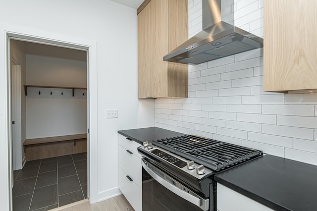 2811 Wildflower Ln SW, Rochester, MN 55902 - kitchen with modern cabinets, dark countertops, wall chimney exhaust hood, and stainless steel range with gas stovetop