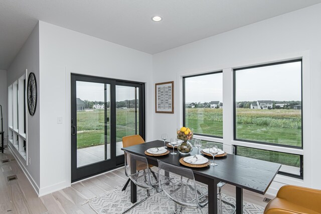 2811 Wildflower Ln SW, Rochester, MN 55902 - dining room with baseboards, light wood finished floors, and recessed lighting