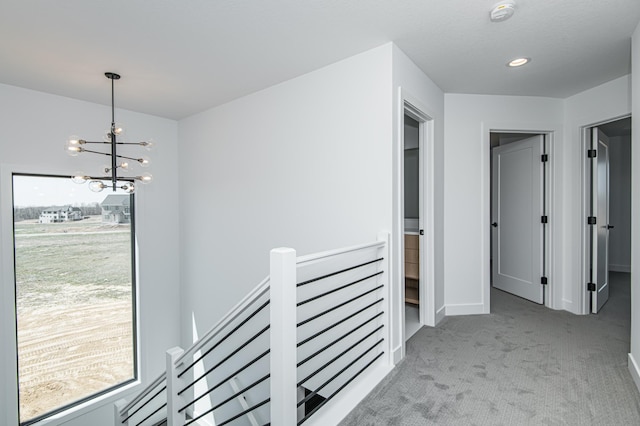2811 Wildflower Ln SW, Rochester, MN 55902 - hall featuring an upstairs landing, an inviting chandelier, baseboards, carpet flooring, and recessed lighting