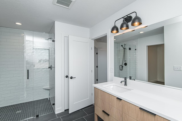 2811 Wildflower Ln SW, Rochester, MN 55902 - full bathroom with recessed lighting, a shower stall, tile patterned floors, visible vents, and vanity