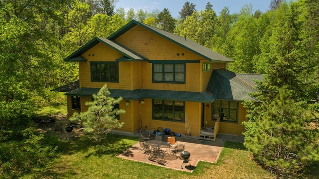 back of house featuring a patio area and a yard