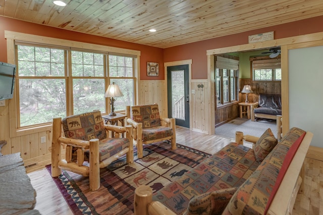 interior space featuring light hardwood / wood-style floors, wood ceiling, and a wealth of natural light