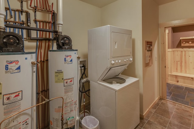 laundry area with stacked washer / drying machine and gas water heater