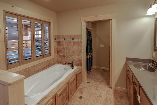 bathroom featuring vanity and a bath