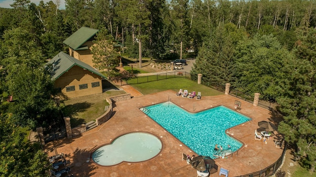 view of pool featuring a patio and a lawn