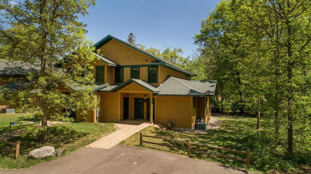 view of front of home featuring central AC and a front yard