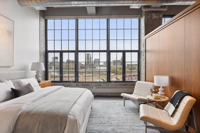 bedroom featuring a towering ceiling and multiple windows