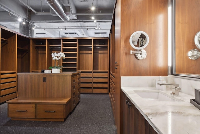 interior space featuring vanity and rail lighting