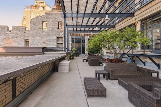 patio terrace at dusk featuring outdoor lounge area and a pergola